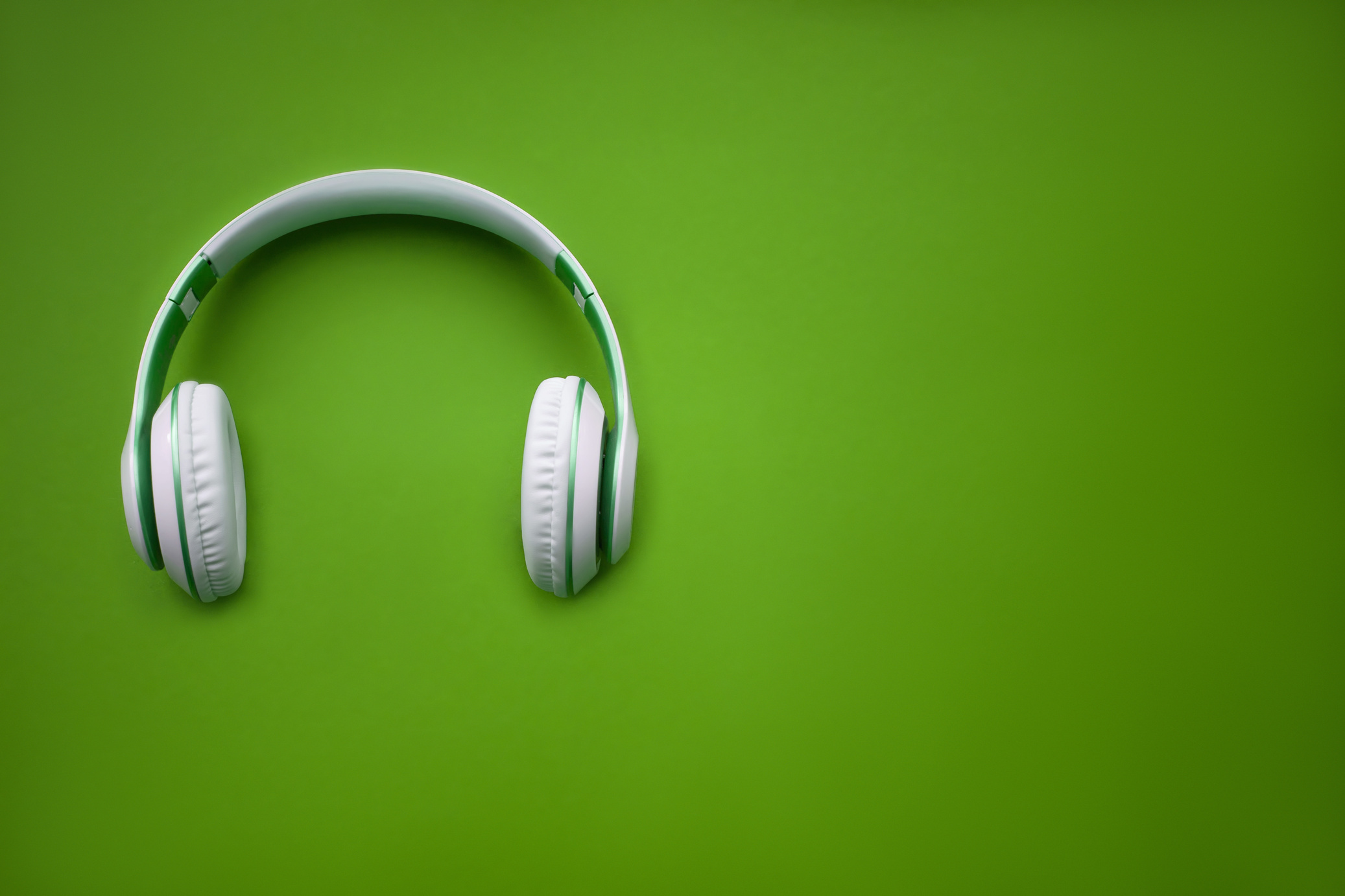 High-quality headphones on a green background. Music concept.
